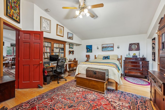 bedroom with high vaulted ceiling and light wood finished floors