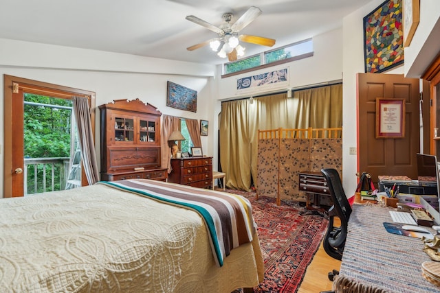 bedroom featuring access to outside, wood finished floors, and ceiling fan