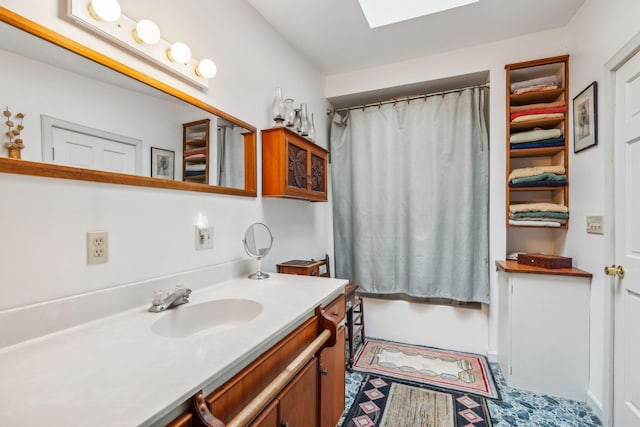 full bathroom featuring shower / bath combo, vanity, and a skylight