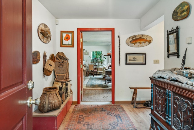 entryway featuring baseboards and wood finished floors
