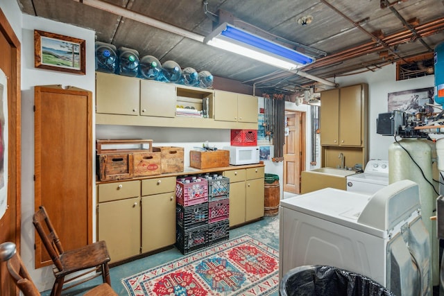 interior space with a sink, cabinet space, and washer / dryer