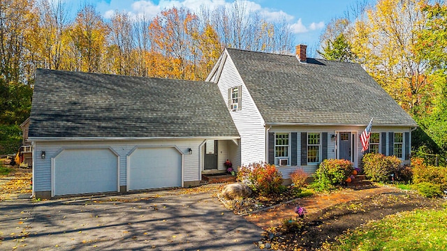 new england style home featuring a garage