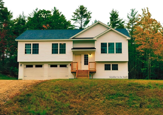 raised ranch with a garage and a front yard