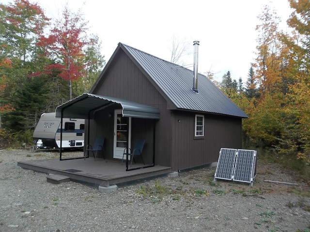 rear view of property featuring central AC and a deck