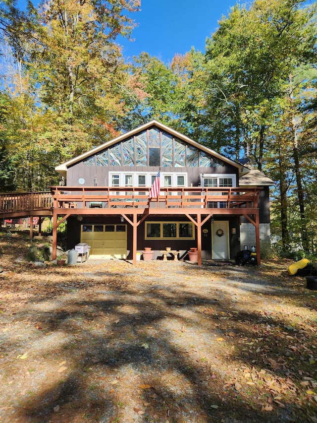 view of front of house with a wooden deck and a garage