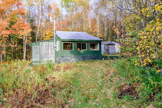 view of outdoor structure with a forest view