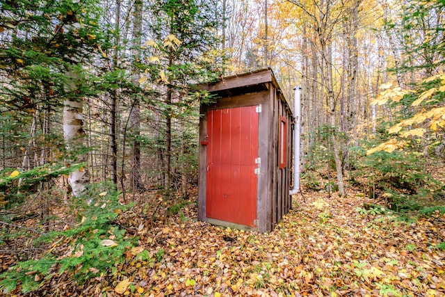 view of shed featuring a forest view