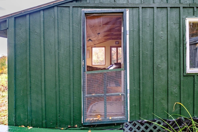 view of exterior entry featuring board and batten siding