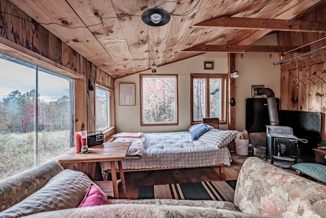 bedroom with a wood stove, wood ceiling, wood finished floors, access to exterior, and vaulted ceiling with beams