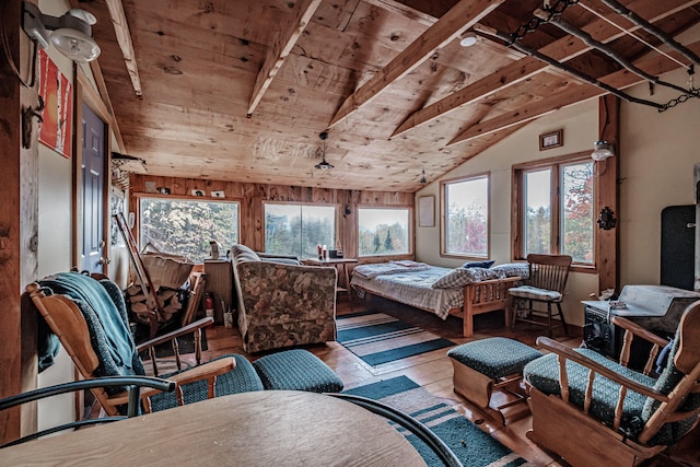 bedroom featuring lofted ceiling with beams, light hardwood / wood-style floors, and wood ceiling