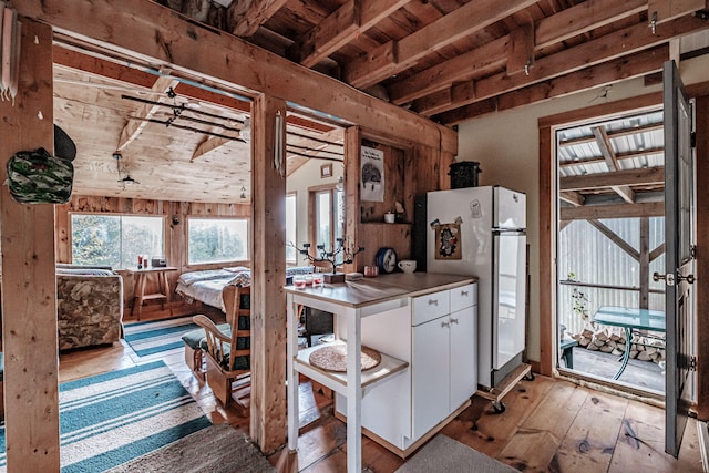 kitchen featuring wooden ceiling, light hardwood / wood-style floors, white fridge, white cabinetry, and vaulted ceiling