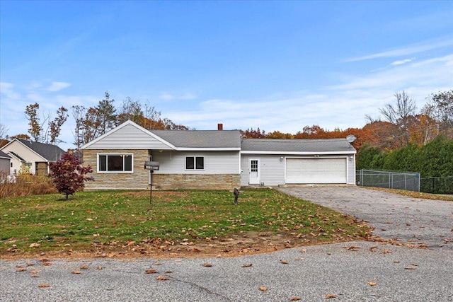 ranch-style home with a garage and a front lawn