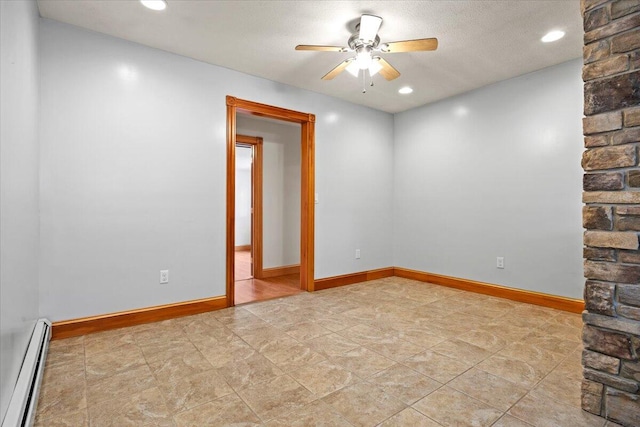 spare room with baseboard heating, a textured ceiling, and ceiling fan