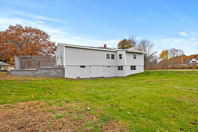 back of property featuring a lawn