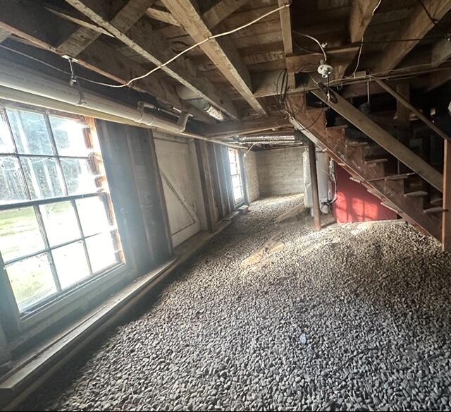 unfinished attic featuring plenty of natural light