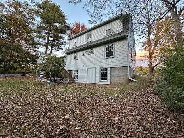 view of back house at dusk