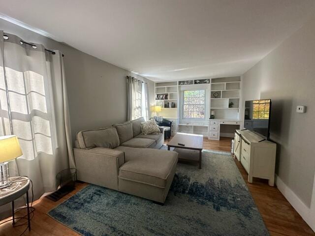 living room featuring hardwood / wood-style floors and built in desk