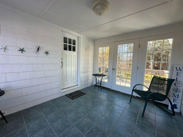 unfurnished sunroom featuring french doors