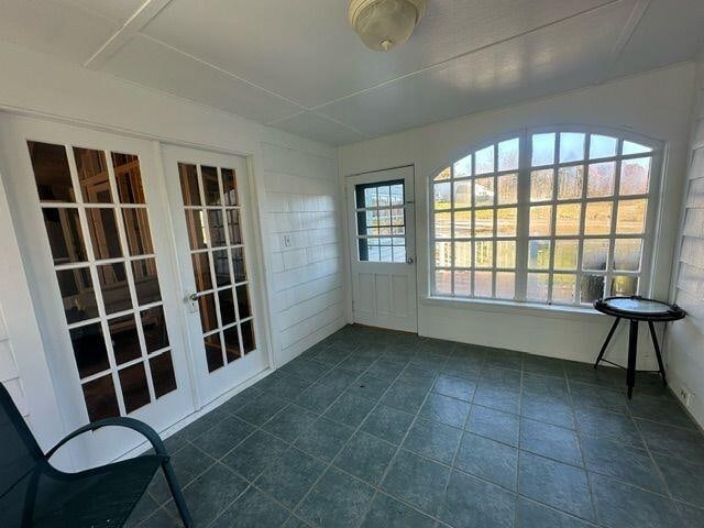 unfurnished sunroom featuring french doors