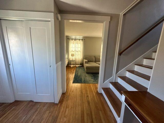 corridor with hardwood / wood-style floors