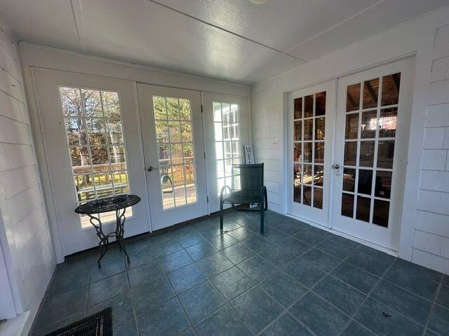 unfurnished sunroom with french doors