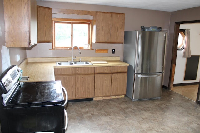 kitchen featuring a sink, stainless steel appliances, and light countertops