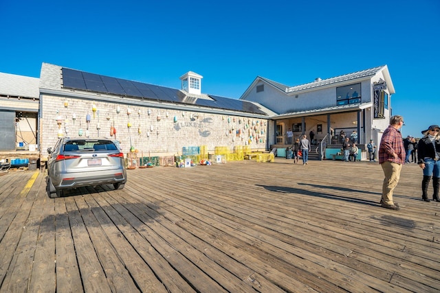 exterior space with a deck and solar panels