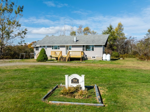 954 Mason Bay Rd, Jonesport, ME 04649 - rear view of house featuring a deck, a shingled roof, and a lawn