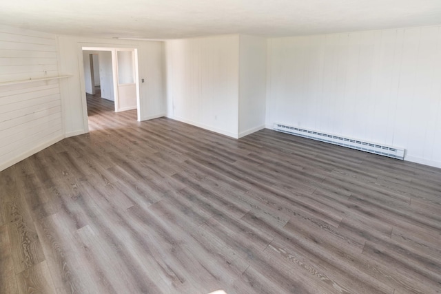 954 Mason Bay Rd, Jonesport, ME 04649 - unfurnished room featuring a baseboard radiator, wood finished floors, and wood walls