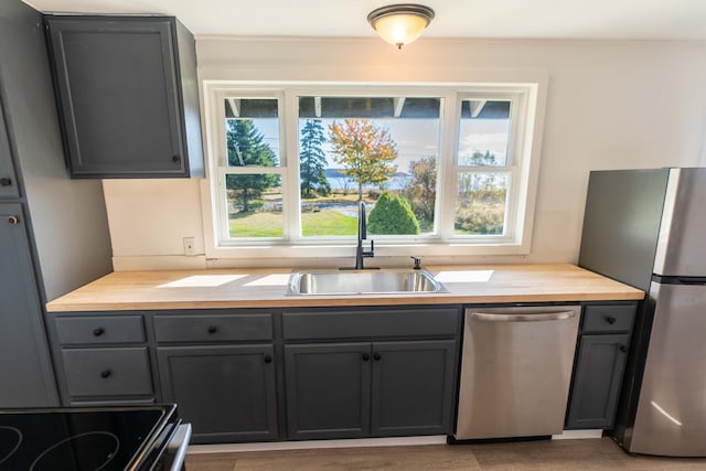 954 Mason Bay Rd, Jonesport, ME 04649 - kitchen with stainless steel appliances, gray cabinetry, and butcher block counters