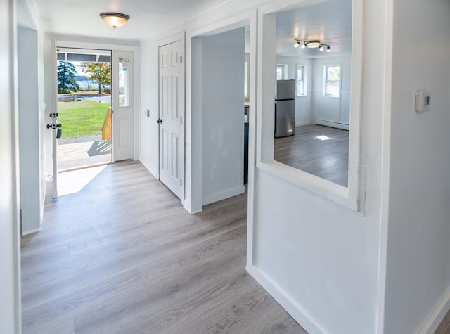 954 Mason Bay Rd, Jonesport, ME 04649 - hallway with wood finished floors and a baseboard radiator