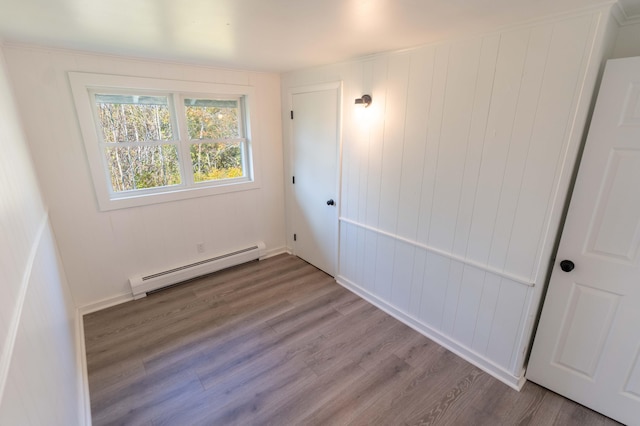 954 Mason Bay Rd, Jonesport, ME 04649 - unfurnished bedroom featuring baseboard heating and wood finished floors