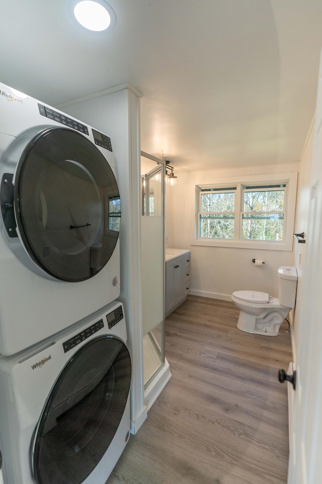 954 Mason Bay Rd, Jonesport, ME 04649 - washroom featuring stacked washer and clothes dryer and light wood-style flooring