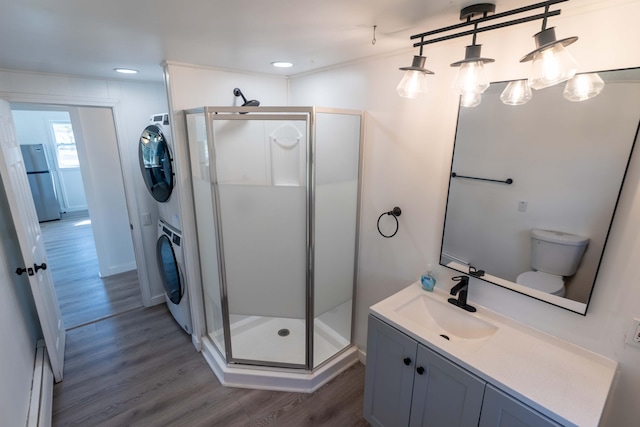954 Mason Bay Rd, Jonesport, ME 04649 - bathroom with stacked washer and clothes dryer, wood finished floors, a stall shower, vanity, and recessed lighting