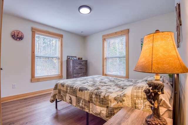 bedroom featuring hardwood / wood-style flooring and multiple windows