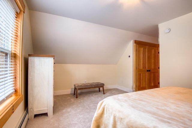 carpeted bedroom with multiple windows, a baseboard radiator, and lofted ceiling