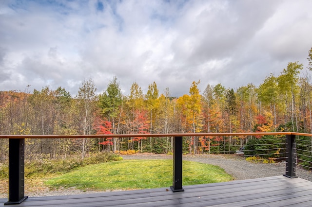 wooden terrace featuring a yard