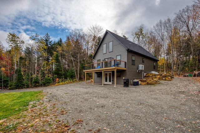 view of side of property featuring central AC, french doors, and a deck