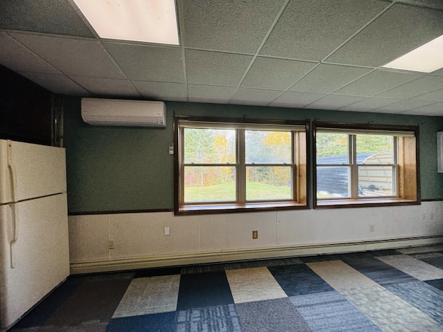 376 Fort Fairfield Rd, Caribou, ME 04736 - unfurnished room featuring a wall mounted air conditioner, a paneled ceiling, and tile patterned floors