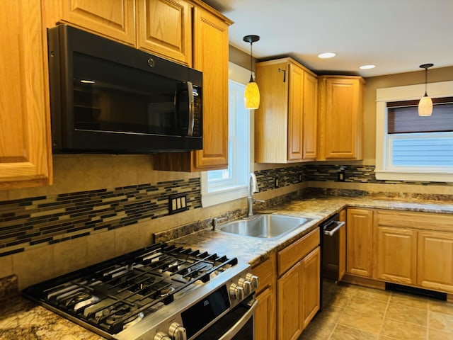 376 Fort Fairfield Rd, Caribou, ME 04736 - kitchen with black microwave, gas range, backsplash, hanging light fixtures, and recessed lighting