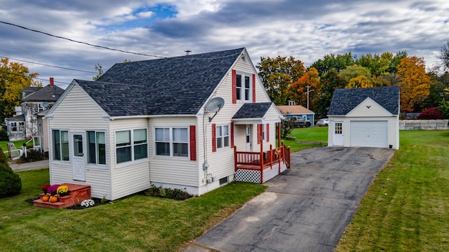 26 Charland St, Winslow, ME 04901 - view of front of house featuring an outbuilding, a garage, a front lawn, roof with shingles, and asphalt driveway