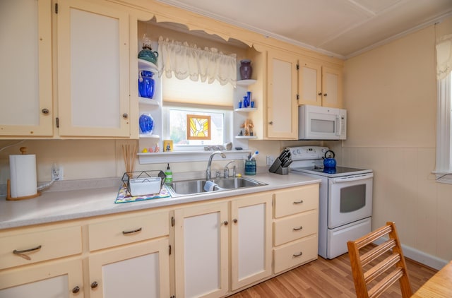 26 Charland St, Winslow, ME 04901 - kitchen featuring white appliances, a sink, light countertops, light wood-style floors, and wainscoting
