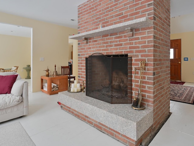 living room with a brick fireplace