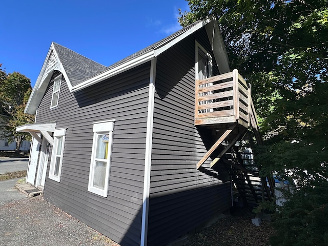 view of side of property with a balcony