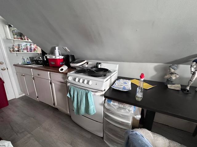 kitchen featuring white cabinets, gas range gas stove, and vaulted ceiling