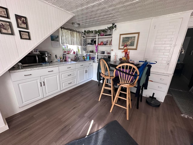 dining room with sink and dark hardwood / wood-style floors