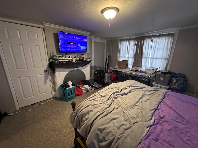 carpeted bedroom featuring a textured ceiling and ornamental molding