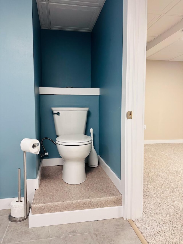 bathroom with baseboards and toilet