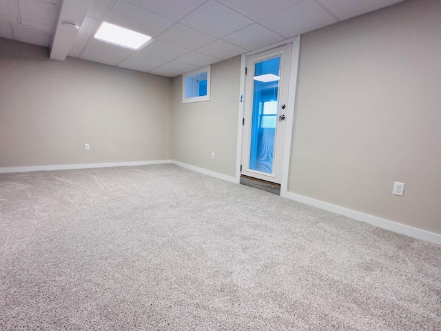 unfurnished room with carpet floors, a paneled ceiling, and baseboards