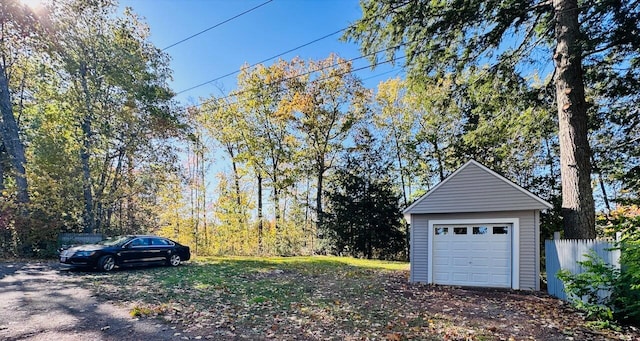 view of yard with a garage, an outdoor structure, and fence